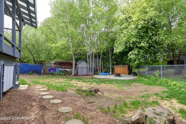 7810 Mae Rene Cir, Anchorage, AK 99502 - fenced backyard with an outdoor fire pit