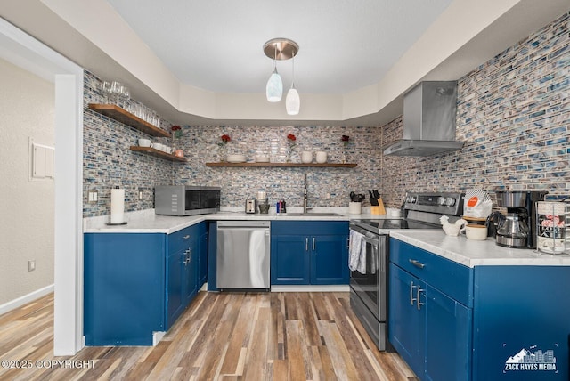 1507 W 47th Ave, Anchorage, AK 99503 - kitchen featuring stainless steel appliances, open shelves, wall chimney exhaust hood, and blue cabinetry