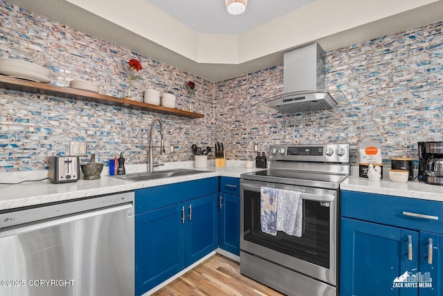 1507 W 47th Ave, Anchorage, AK 99503 - kitchen featuring appliances with stainless steel finishes, blue cabinetry, decorative backsplash, open shelves, and exhaust hood