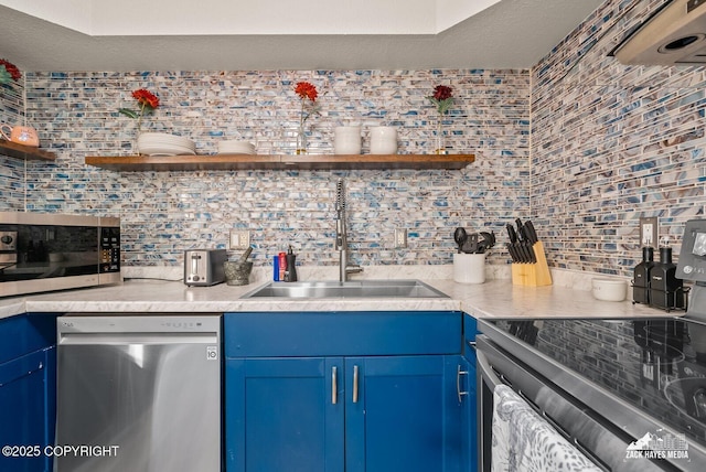 1507 W 47th Ave, Anchorage, AK 99503 - kitchen featuring stainless steel appliances, blue cabinets, open shelves, and decorative backsplash