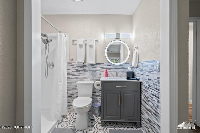 1507 W 47th Ave, Anchorage, AK 99503 - bathroom with vanity, a shower with shower curtain, and tile walls