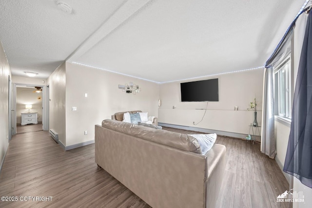 1507 W 47th Ave, Anchorage, AK 99503 - living room featuring a baseboard heating unit, wood finished floors, a textured ceiling, and a ceiling fan