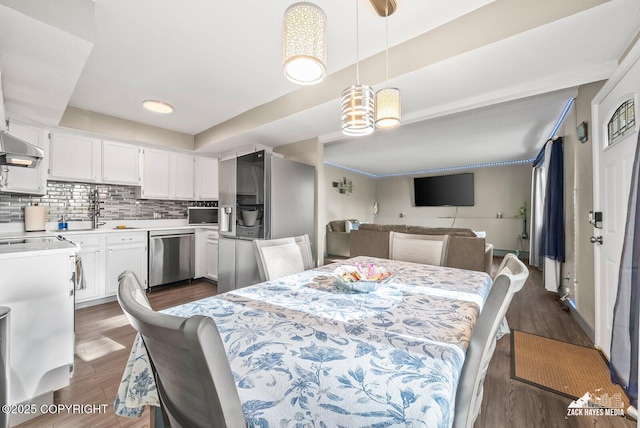 1507 W 47th Ave, Anchorage, AK 99503 - dining area featuring dark wood-style flooring and a chandelier