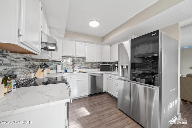 1507 W 47th Ave, Anchorage, AK 99503 - kitchen featuring stainless steel appliances, under cabinet range hood, tasteful backsplash, light countertops, and white cabinets