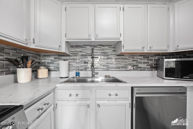 1507 W 47th Ave, Anchorage, AK 99503 - kitchen with stainless steel appliances, white cabinets, and tasteful backsplash
