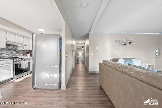 1507 W 47th Ave, Anchorage, AK 99503 - hallway featuring light wood-style flooring and a textured ceiling