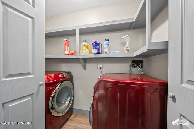 1507 W 47th Ave, Anchorage, AK 99503 - washroom with washing machine and clothes dryer and wood finished floors