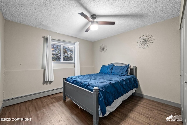 1507 W 47th Ave, Anchorage, AK 99503 - bedroom with a baseboard radiator, a textured ceiling, wood finished floors, and a ceiling fan