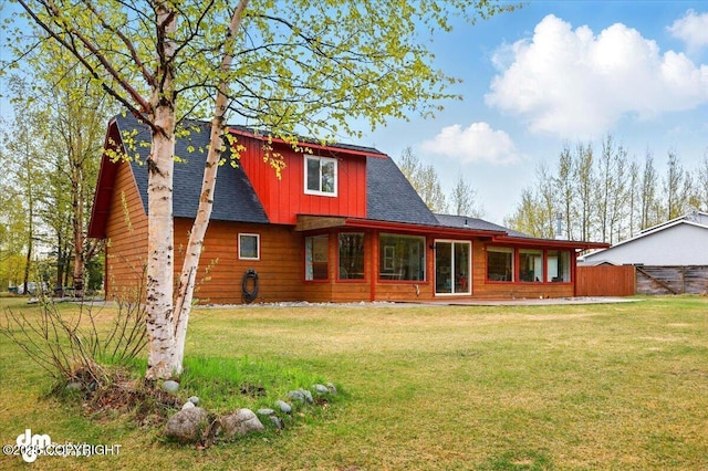 rear view of property with roof with shingles and board and batten siding