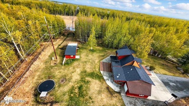 view from above of property with a heavily wooded area