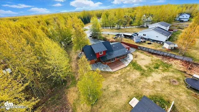 view of subject property with a heavily wooded area