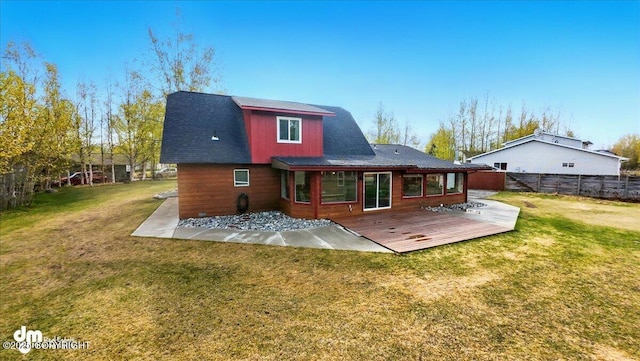 back of property featuring a deck and roof with shingles