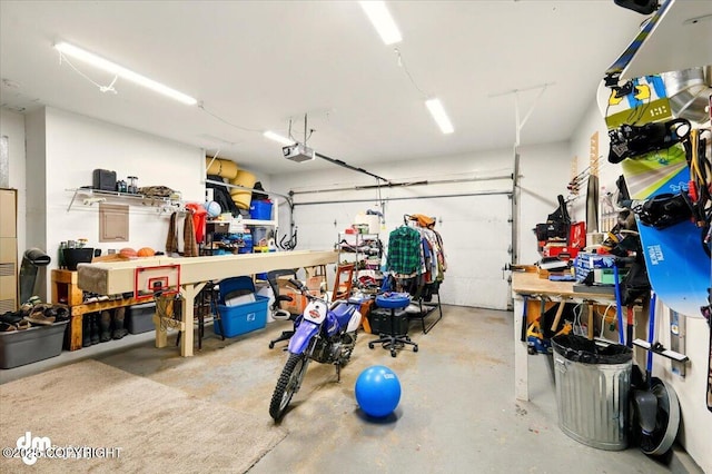 garage with a workshop area and a garage door opener
