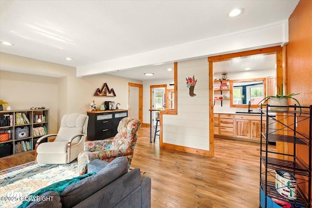 living room with light wood-style flooring and recessed lighting