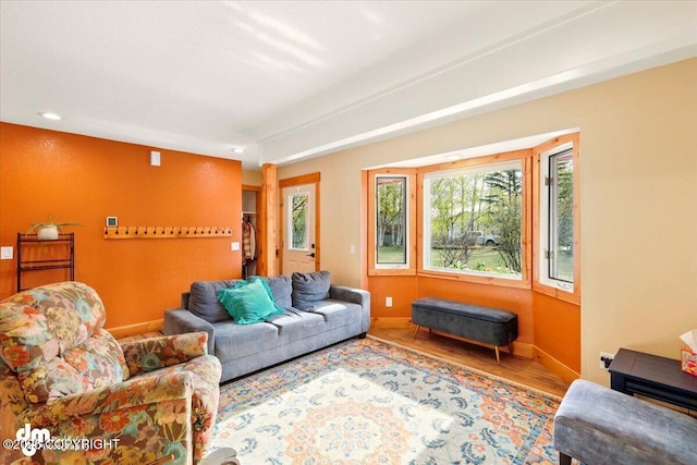 living room with baseboards, wood finished floors, and recessed lighting
