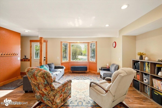 living area featuring wood finished floors, recessed lighting, and baseboards