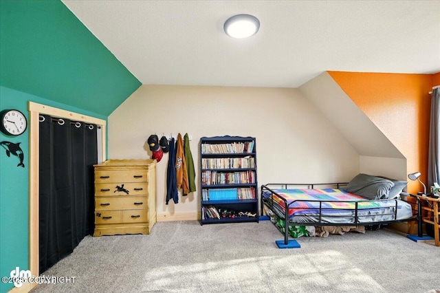 carpeted bedroom featuring lofted ceiling
