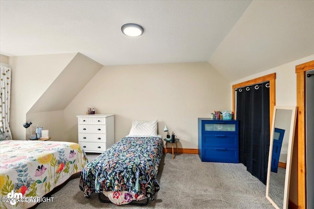 bedroom featuring carpet floors and lofted ceiling
