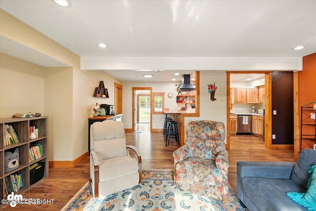 living area with light wood-style floors, baseboards, and recessed lighting