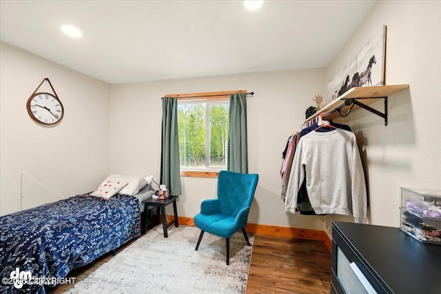 bedroom featuring wood finished floors, baseboards, and recessed lighting