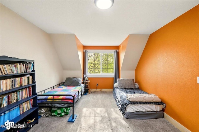 bedroom featuring carpet and vaulted ceiling