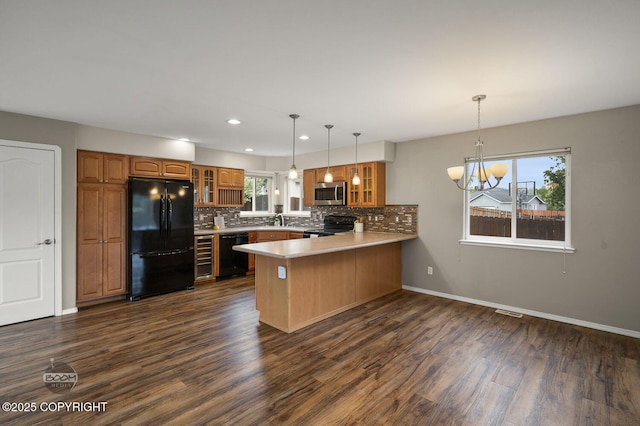 16422 Ondola Cir, Eagle River, AK 99577 - kitchen featuring black appliances, a peninsula, glass insert cabinets, decorative backsplash, and recessed lighting
