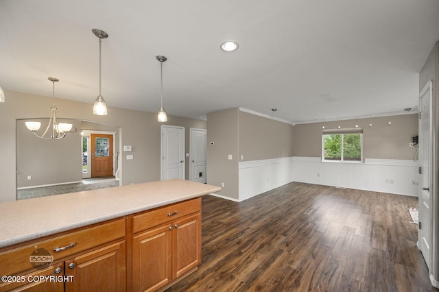 16422 Ondola Cir, Eagle River, AK 99577 - kitchen with open floor plan, dark wood-type flooring, a chandelier, a wainscoted wall, and brown cabinetry