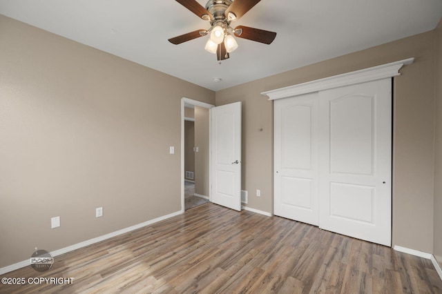 16422 Ondola Cir, Eagle River, AK 99577 - unfurnished bedroom featuring wood finished floors, a closet, and a ceiling fan