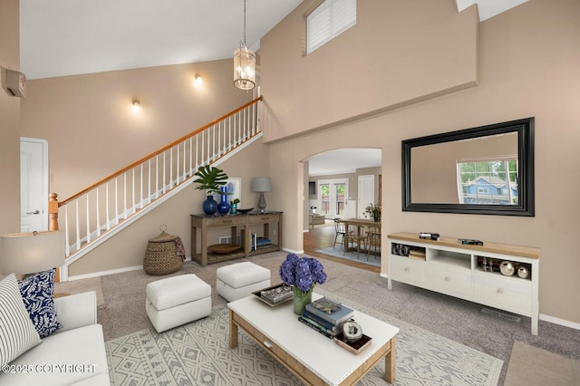 16422 Ondola Cir, Eagle River, AK 99577 - living area featuring a high ceiling, arched walkways, stairs, and carpet flooring