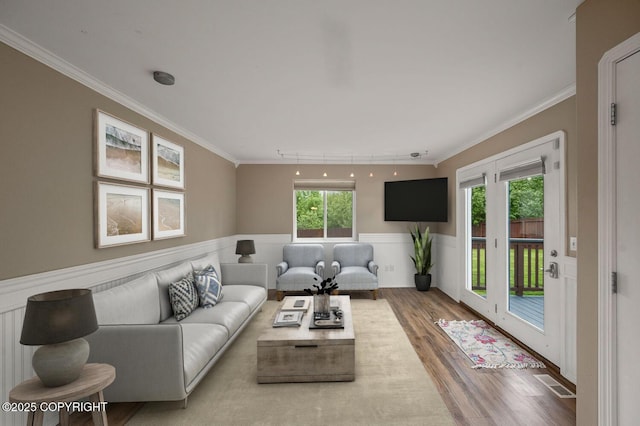 16422 Ondola Cir, Eagle River, AK 99577 - living room featuring ornamental molding, wood finished floors, and wainscoting