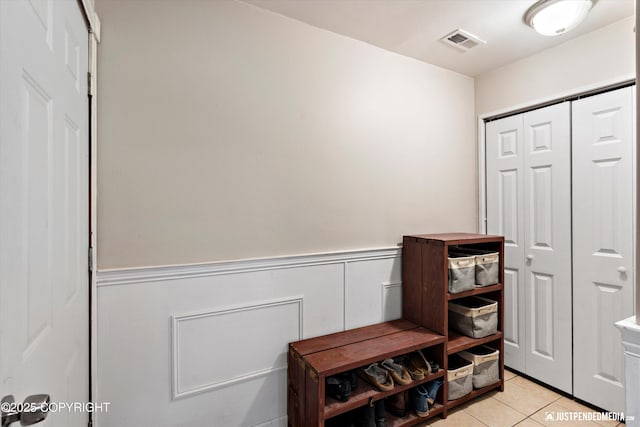 2435 N Ravens Flight Dr, Wasilla, AK 99654 - mudroom with wainscoting and light tile patterned floors