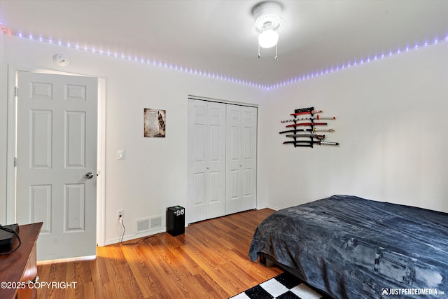 2435 N Ravens Flight Dr, Wasilla, AK 99654 - bedroom with wood finished floors, a closet, and baseboards