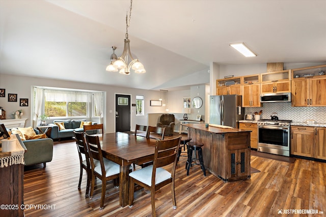 2435 N Ravens Flight Dr, Wasilla, AK 99654 - dining room featuring lofted ceiling, dark wood finished floors, and a chandelier