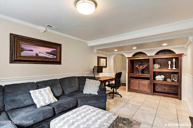 2435 N Ravens Flight Dr, Wasilla, AK 99654 - living area with crown molding, arched walkways, light tile patterned flooring, recessed lighting, and a wainscoted wall