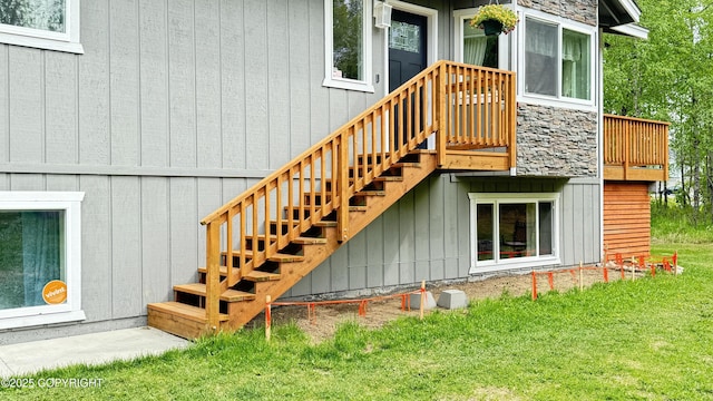 2435 N Ravens Flight Dr, Wasilla, AK 99654 - view of exterior entry with a yard and stone siding