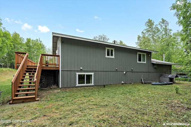 2435 N Ravens Flight Dr, Wasilla, AK 99654 - back of property featuring stairway, a deck, and a lawn