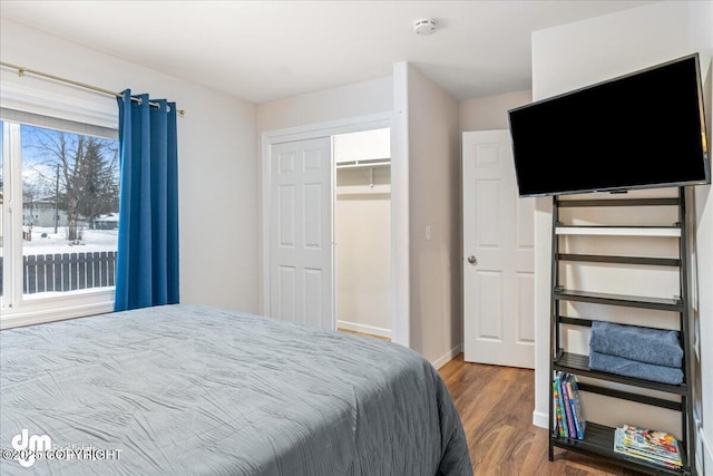 bedroom featuring wood finished floors and baseboards
