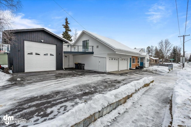view of snow covered exterior featuring a garage