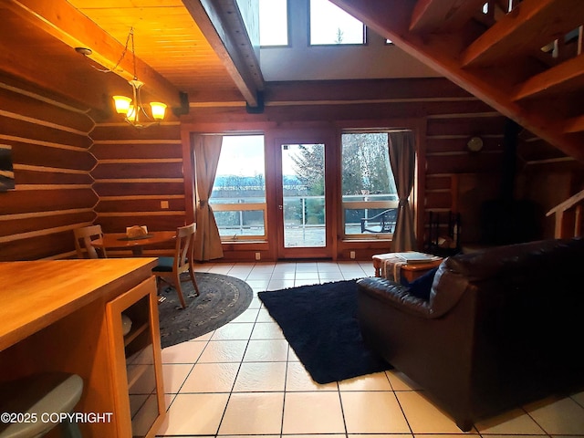 living area with light tile patterned floors, beam ceiling, and healthy amount of natural light