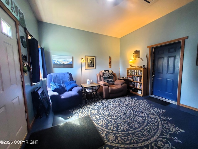 carpeted living area featuring baseboards
