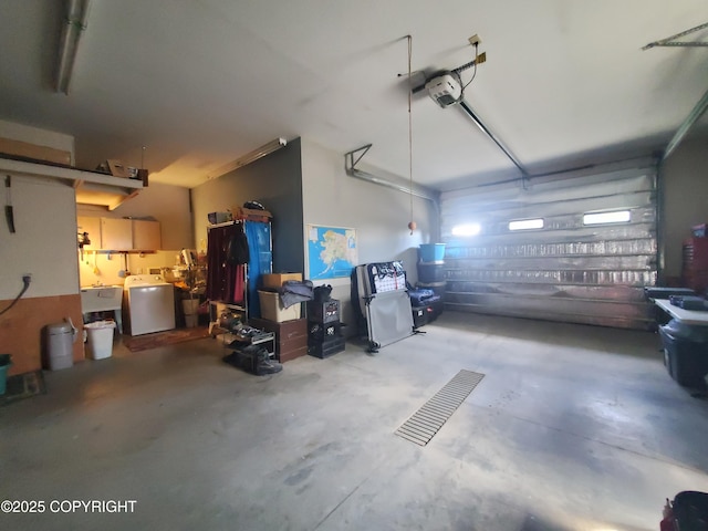 garage featuring washer / clothes dryer, a sink, and a garage door opener