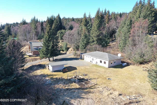 view from above of property with a forest