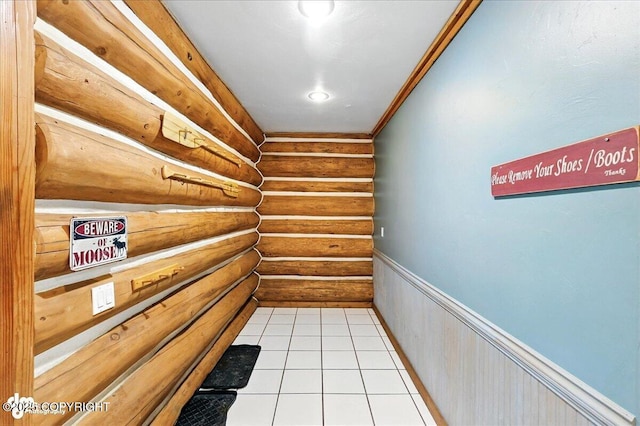 4510 Thomas Ct, Homer, AK 99603 - hall with log walls, tile patterned flooring, and wainscoting