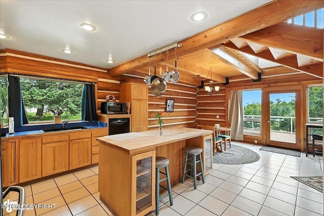 4510 Thomas Ct, Homer, AK 99603 - kitchen featuring log walls, stainless steel microwave, wood counters, light tile patterned floors, and beamed ceiling