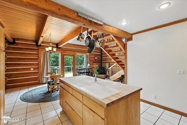 4510 Thomas Ct, Homer, AK 99603 - kitchen with log walls, a wood stove, light tile patterned floors, recessed lighting, and pendant lighting