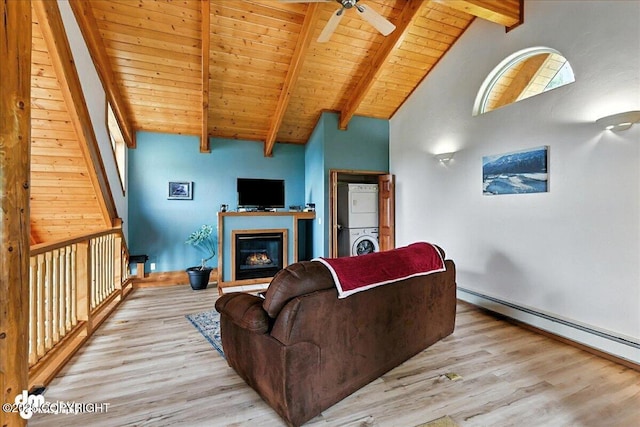 4510 Thomas Ct, Homer, AK 99603 - living area with stacked washer and clothes dryer, wood finished floors, ceiling fan, a wooden ceiling with exposed beams, and a baseboard radiator