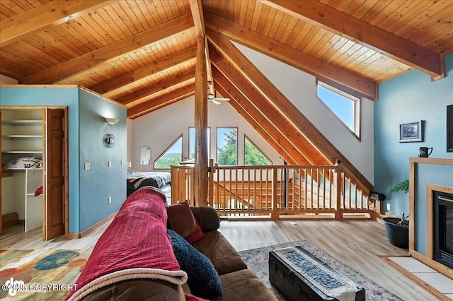 4510 Thomas Ct, Homer, AK 99603 - living area with healthy amount of natural light, wood finished floors, wooden ceiling, ceiling fan, and a fireplace with flush hearth