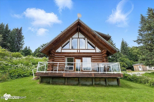 4510 Thomas Ct, Homer, AK 99603 - rear view of property featuring log exterior, a lawn, a wooden deck, and a storage shed