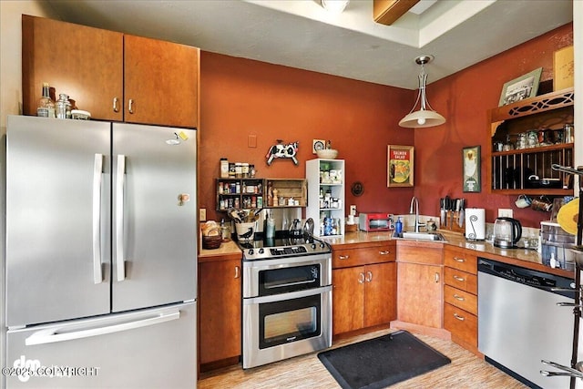 4510 Thomas Ct, Homer, AK 99603 - kitchen featuring stainless steel appliances, light wood finished floors, brown cabinetry, and light countertops