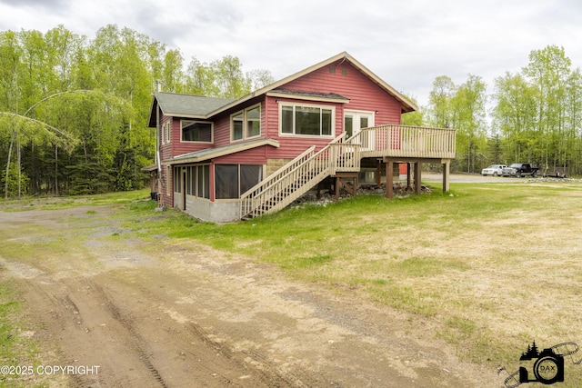 4800 W Lucy Lake Rd, Wasilla, AK 99623 - chalet / cabin with a deck, stairs, a sunroom, and a front lawn